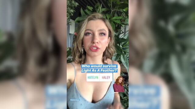 Katelyn Nacon outside in a blue dress, nice cleavage