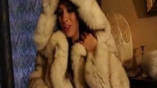 Brunette in white fur coat playing with herself
